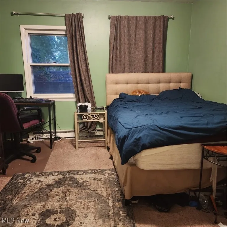 Bedroom with baseboards and a desk