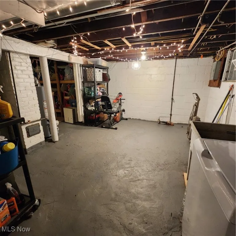 Unfinished below grade area with washer / dryer and water heater