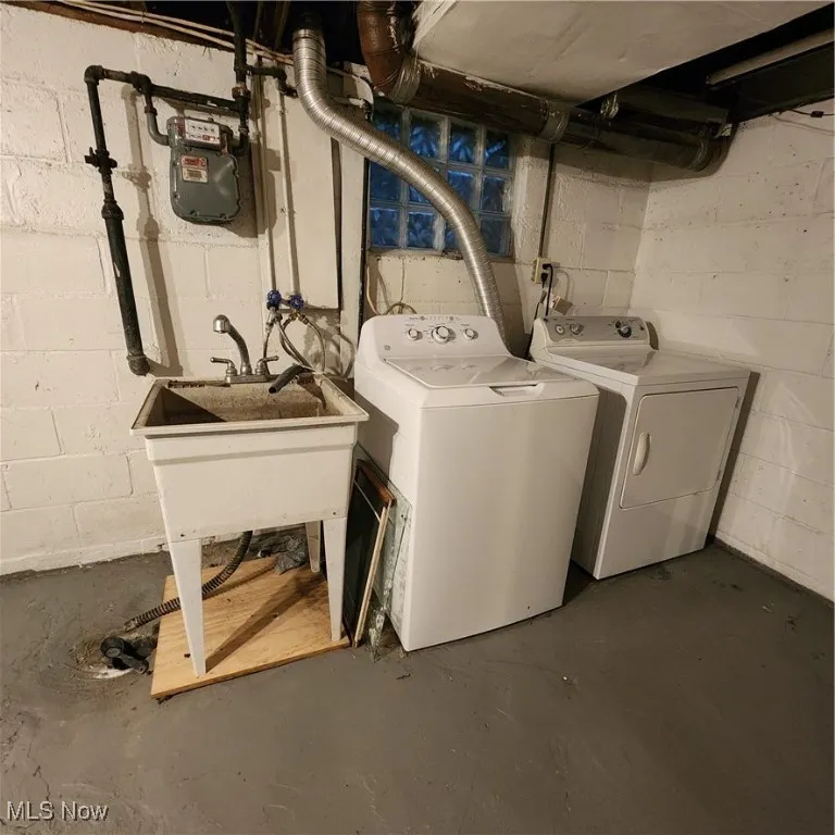 Laundry room with concrete flooring and independent washer and dryer