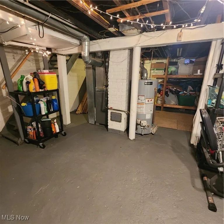 Unfinished below grade area featuring water heater