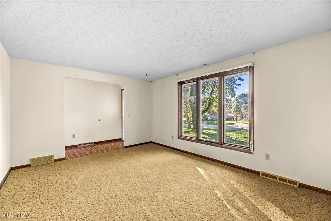 Carpeted living room to the left when entering the front door