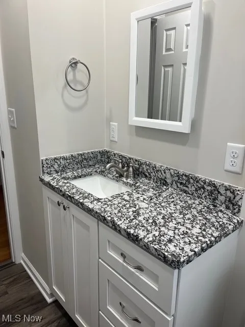 Bathroom with vanity and dark wood finished floors