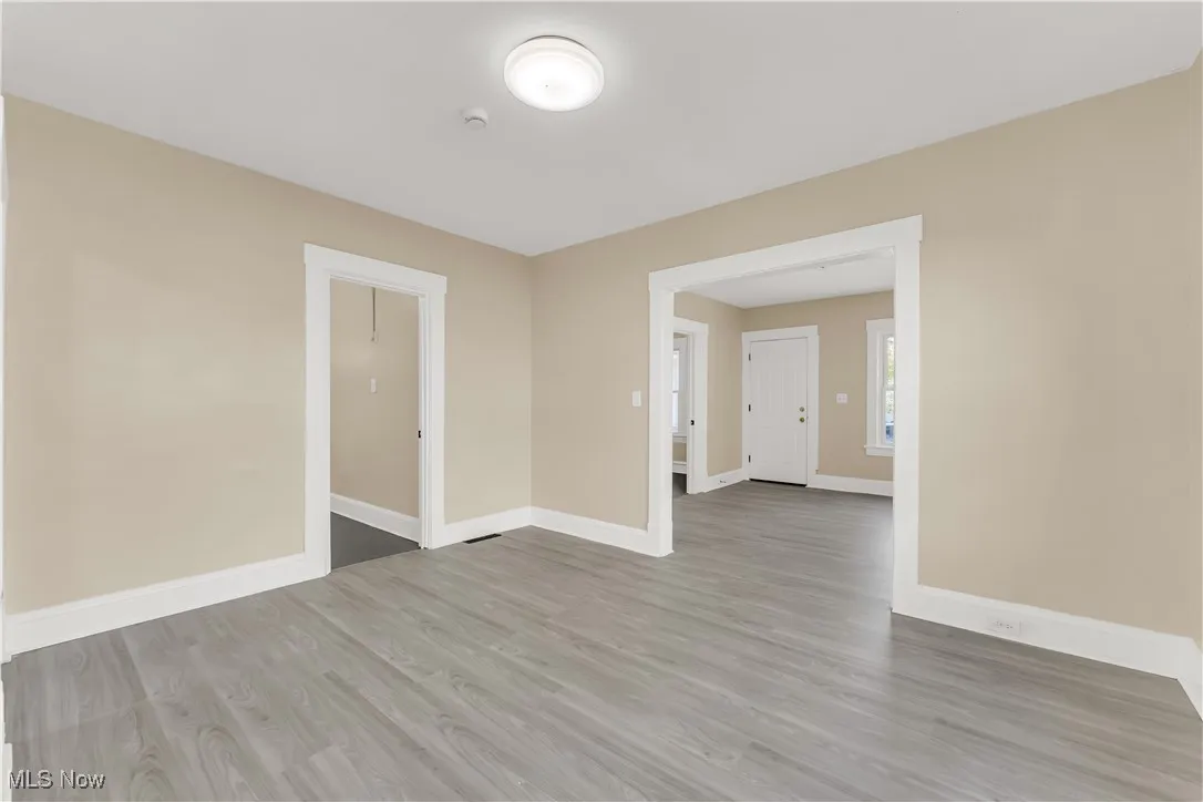 Spare room featuring wood finished floors and baseboards