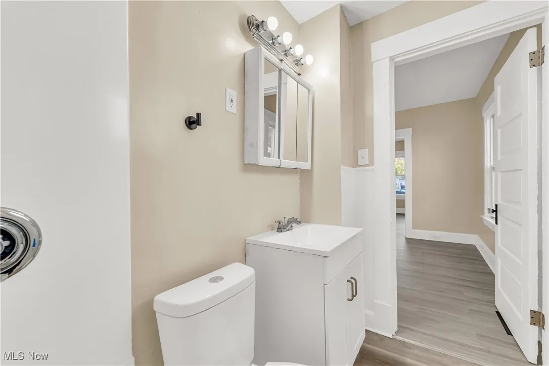 Half bath with vanity and light wood-style flooring