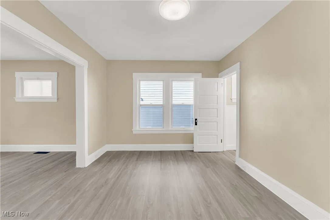 Spare room with light wood-style floors and baseboards