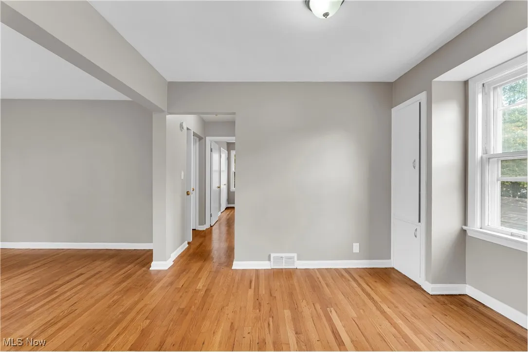 Unfurnished room with baseboards and light wood-style flooring