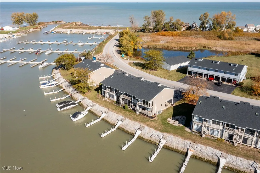 Drone / aerial view of a nearby body of water and a marina