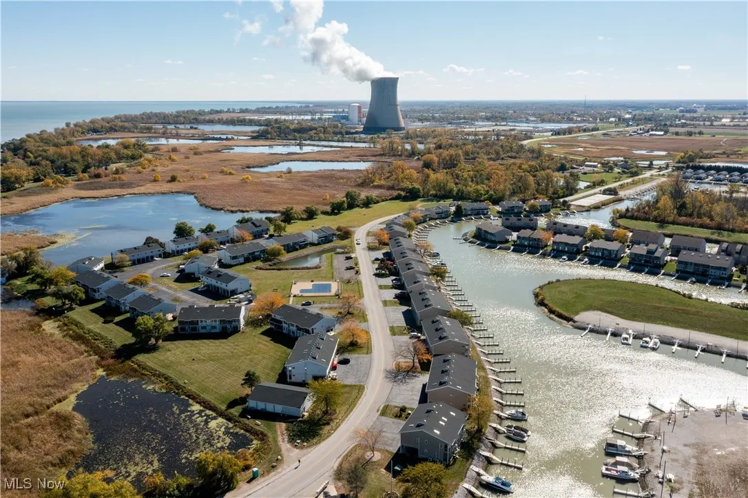 Aerial view of property's location featuring a large body of water and nearby suburban area