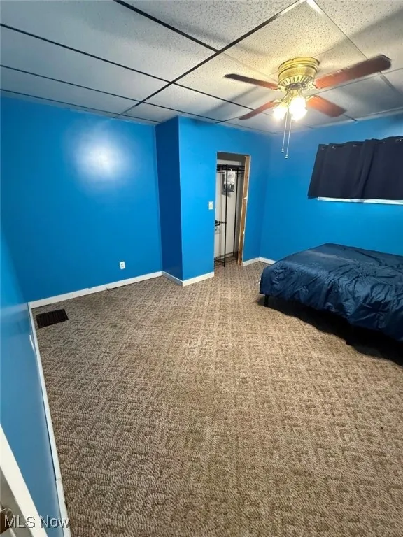 Bedroom with carpet floors, ceiling fan, and a closet