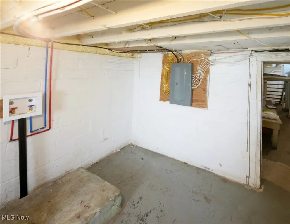 Unfinished basement with electric panel and washer/dryer hook-up
