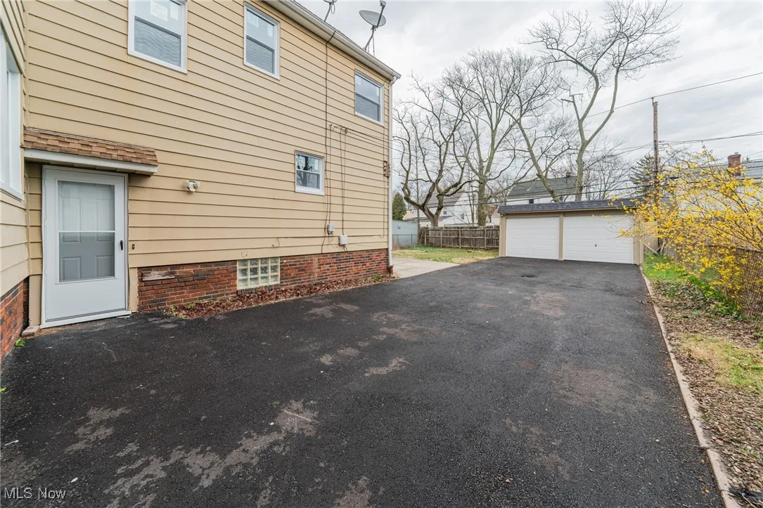 View of side of home featuring an outdoor structure and a garage
