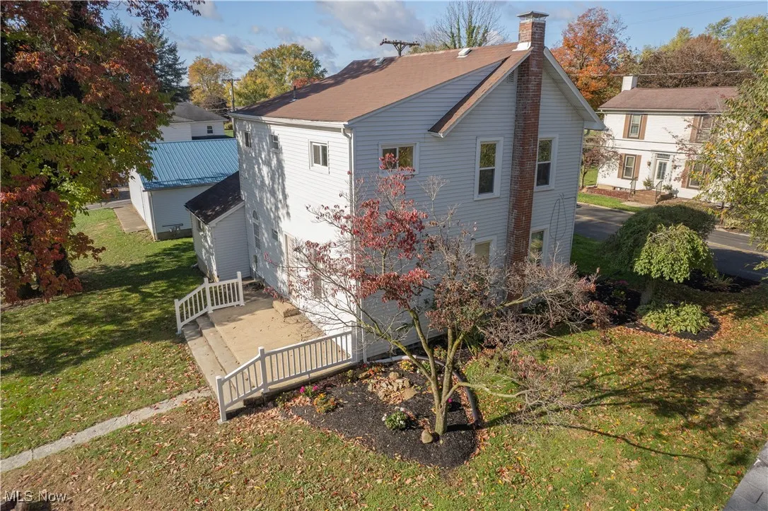 Back of house featuring a deck and backyard