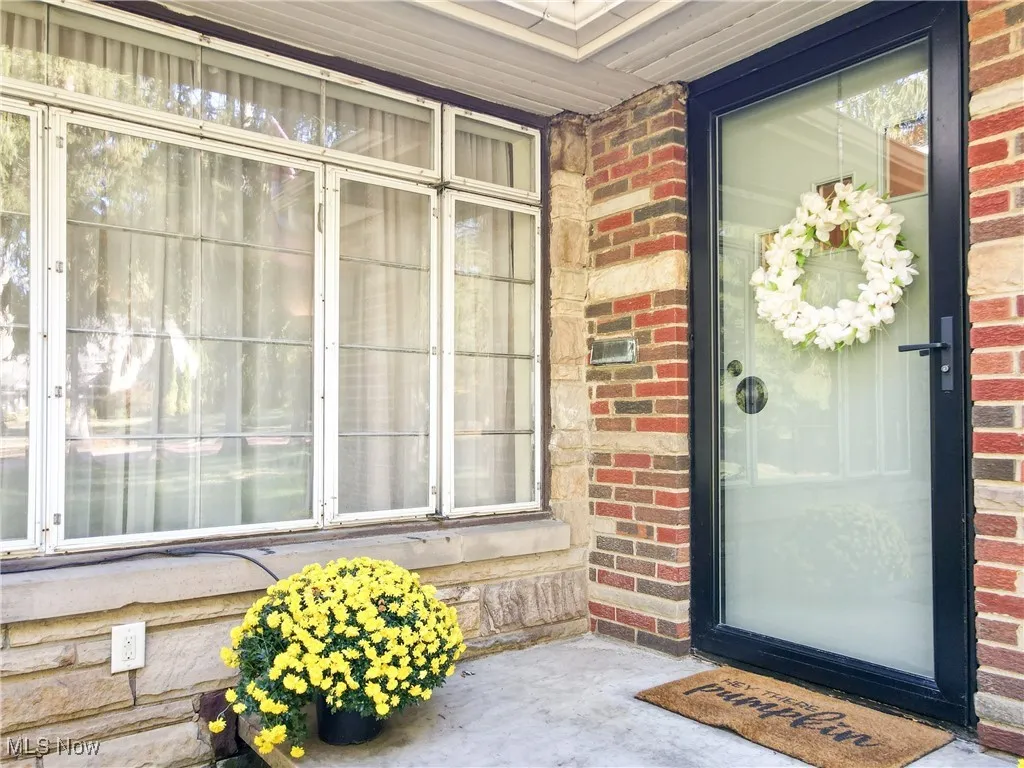 View of exterior entry with brick siding