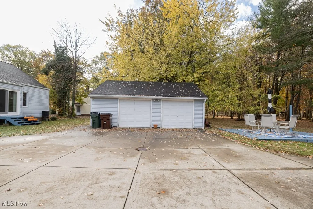 Detached garage with view of wooded area