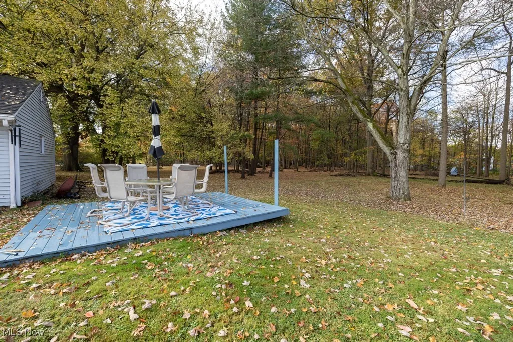 View of green lawn with a deck