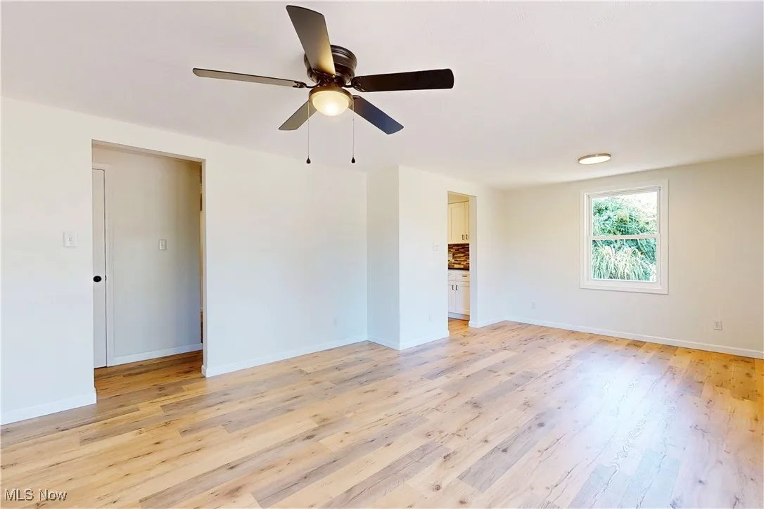 Spare room with light wood-style flooring and ceiling fan