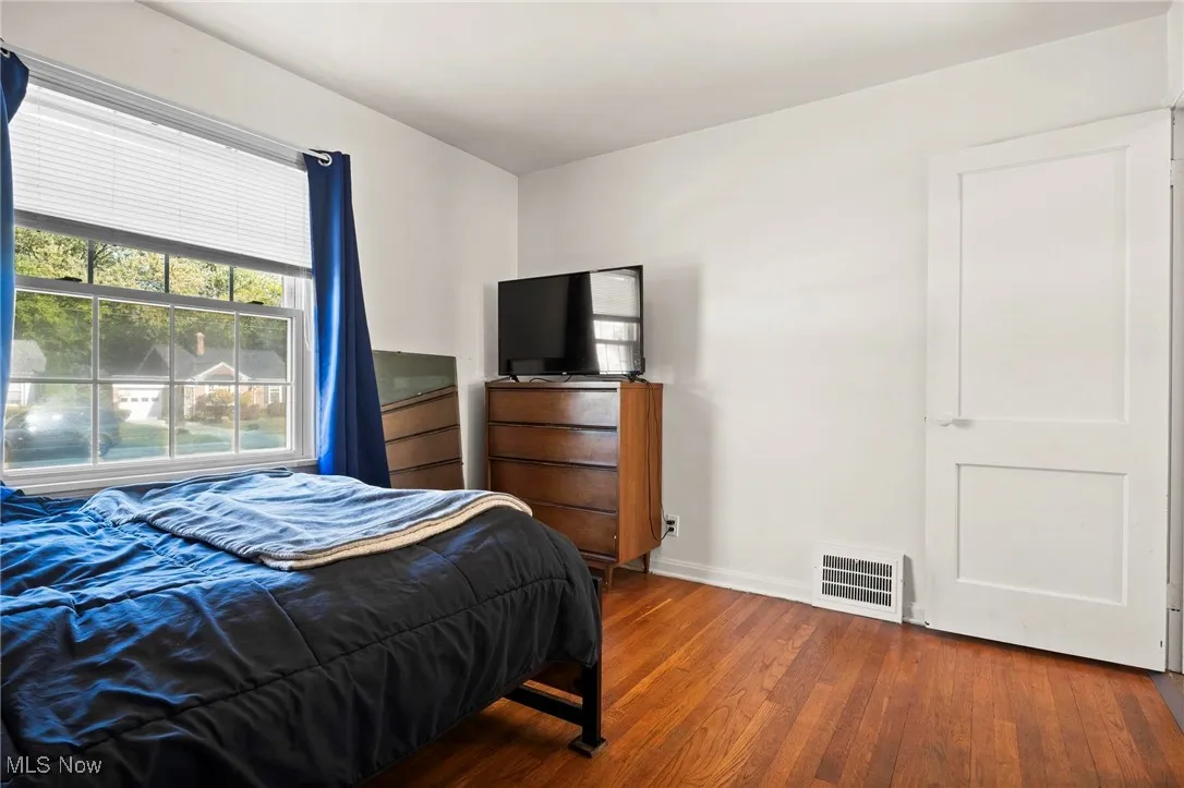 Bedroom with wood-type flooring and baseboards
