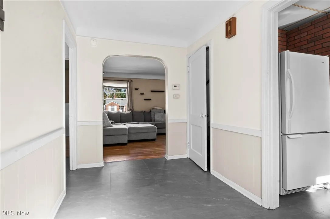 Hall with arched walkways and a wainscoted wall