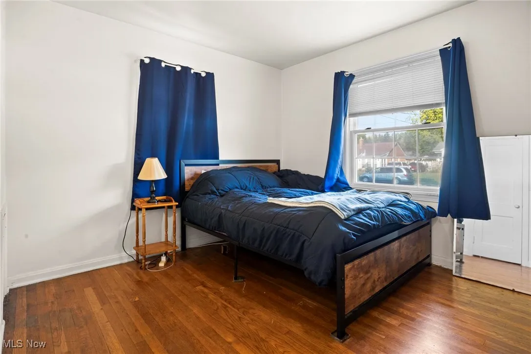 Bedroom with hardwood / wood-style flooring
