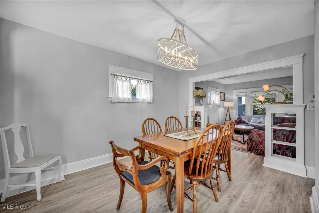 Dining room featuring light wood-type flooring and a chandelier