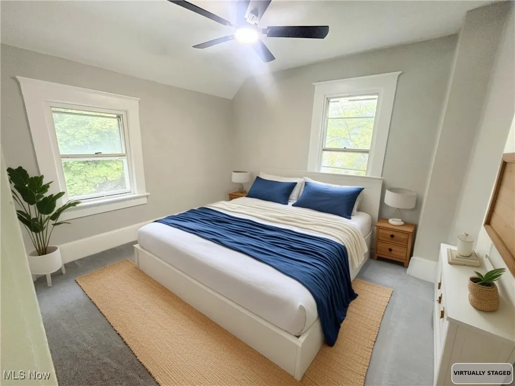 Bedroom featuring carpet flooring, ceiling fan, and lofted ceiling