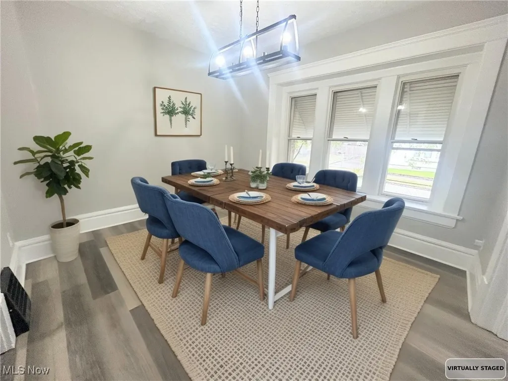 Dining room with baseboards and dark wood finished floors
