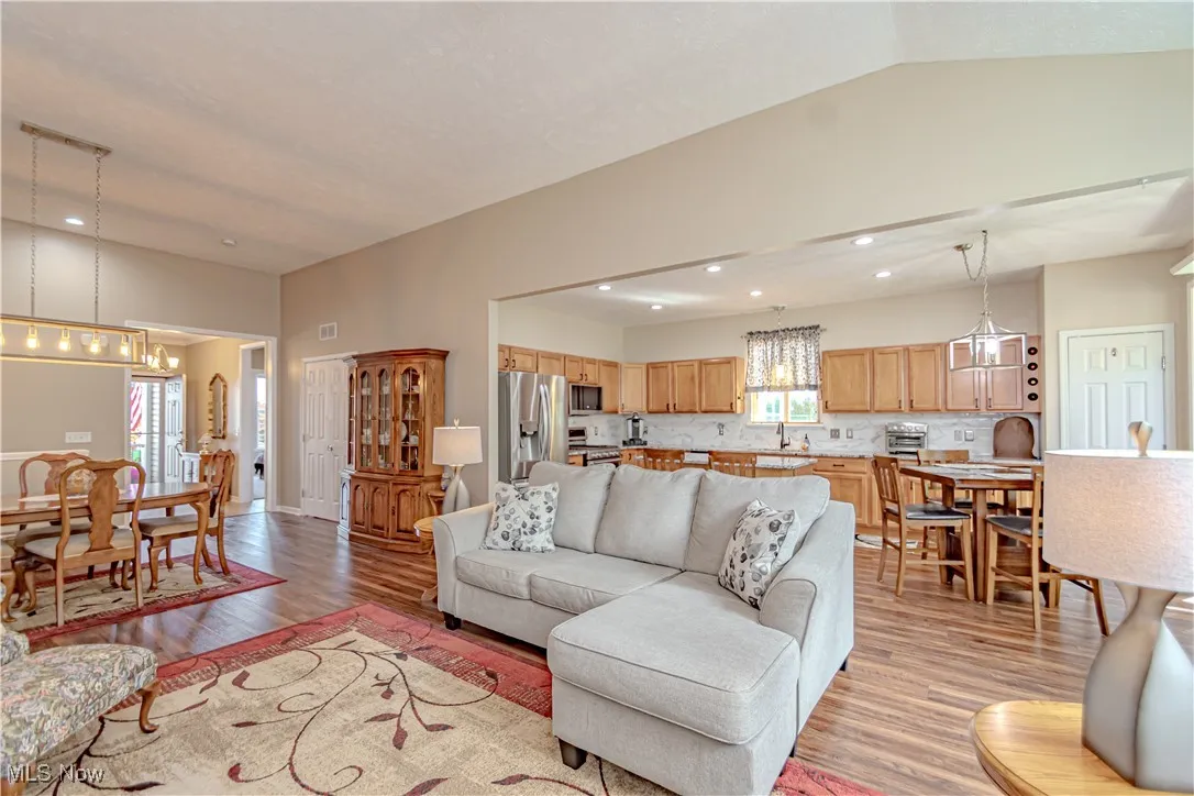Living area with light wood-type flooring, a chandelier, and recessed lighting