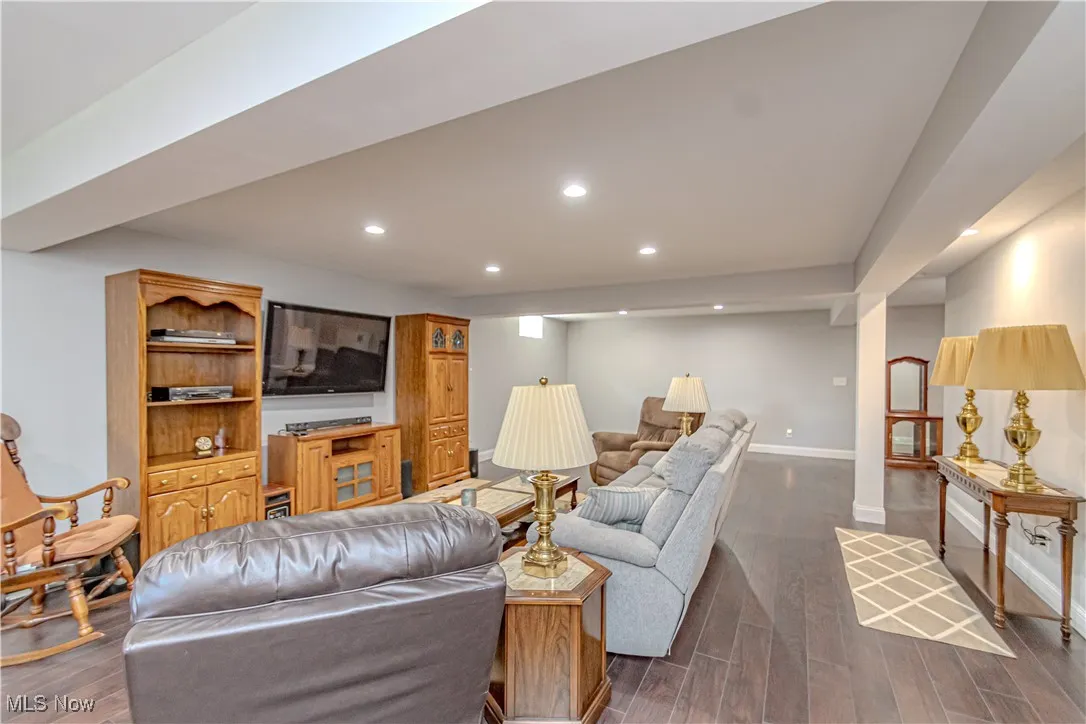 Living area with recessed lighting and dark wood finished floors