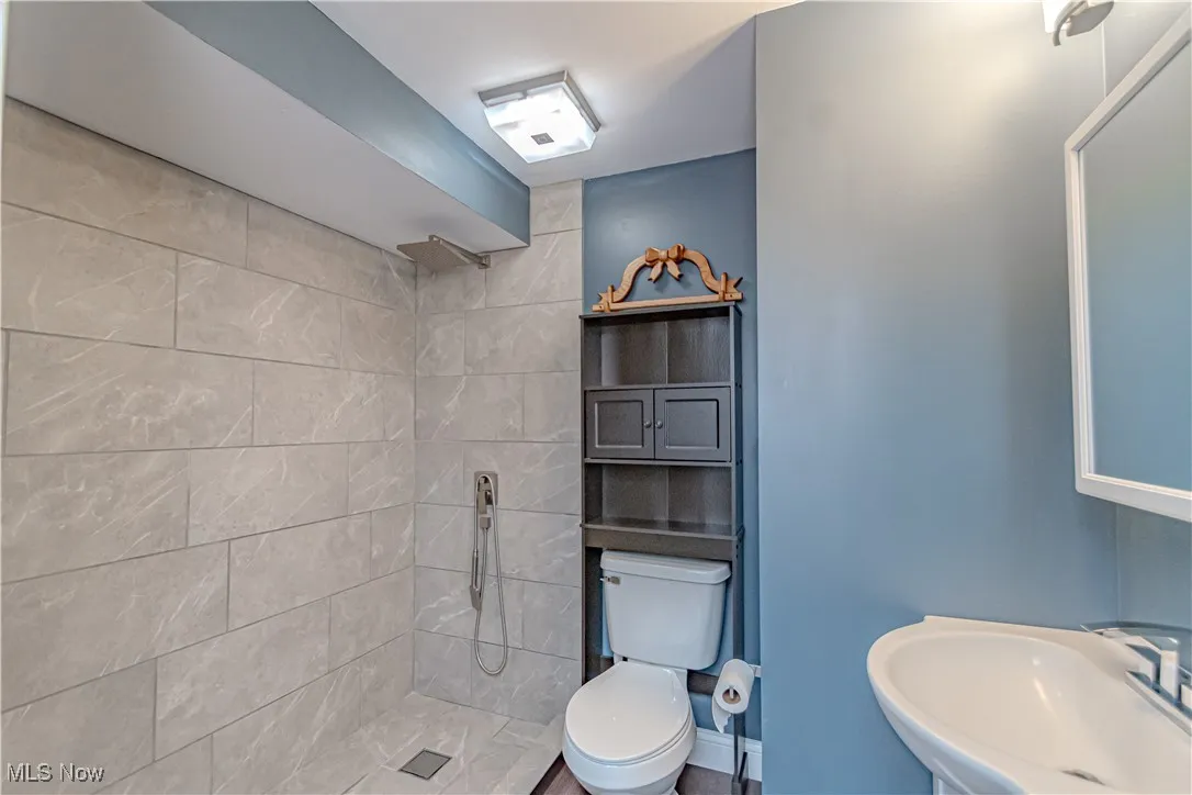 Bathroom with a walk in shower and a sink