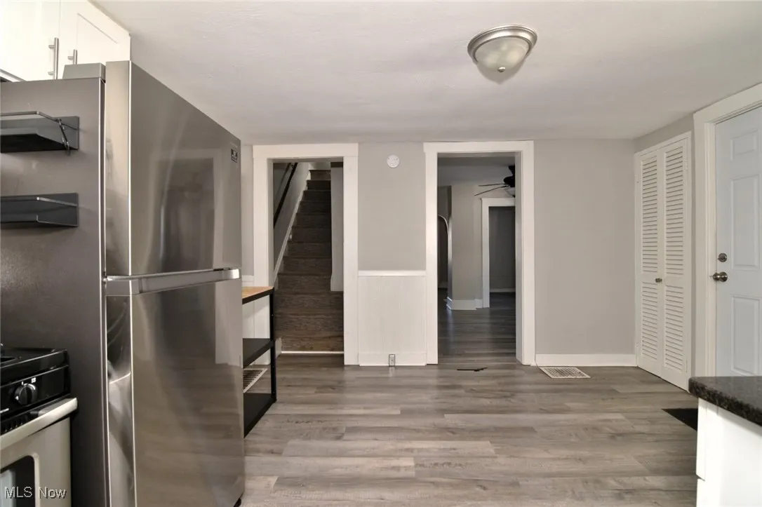 Kitchen featuring light wood finished floors, white cabinetry, and appliances with stainless steel finishes