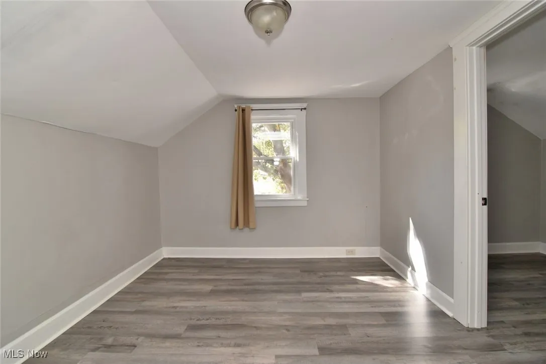 Bonus room featuring wood finished floors and vaulted ceiling