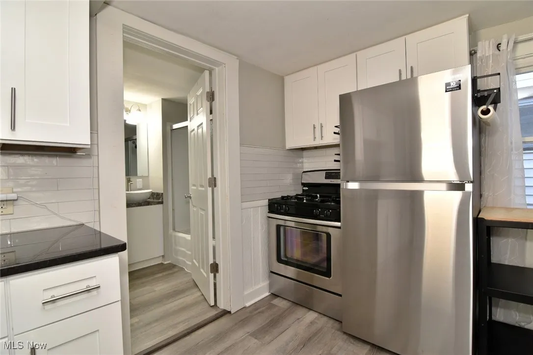 Kitchen with appliances with stainless steel finishes and white cabinets