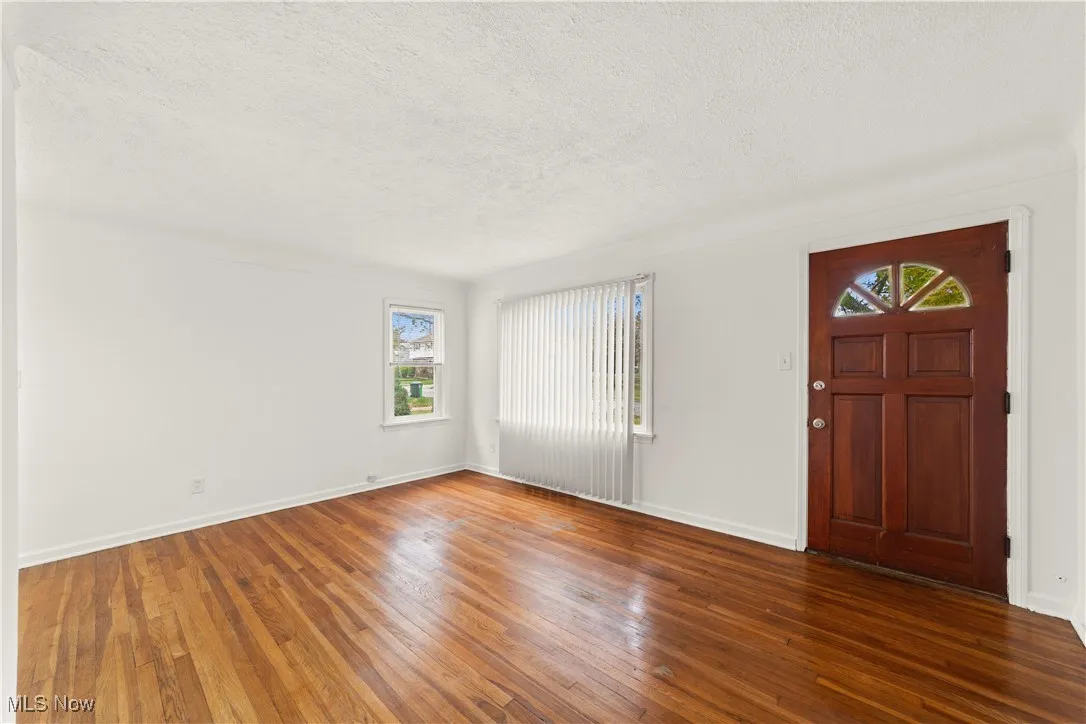 Freshly painted and Entry to Open Living Room with Hard Wood Floors