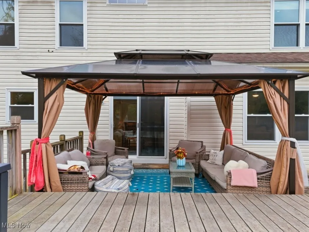 Deck featuring an outdoor hangout area and a gazebo