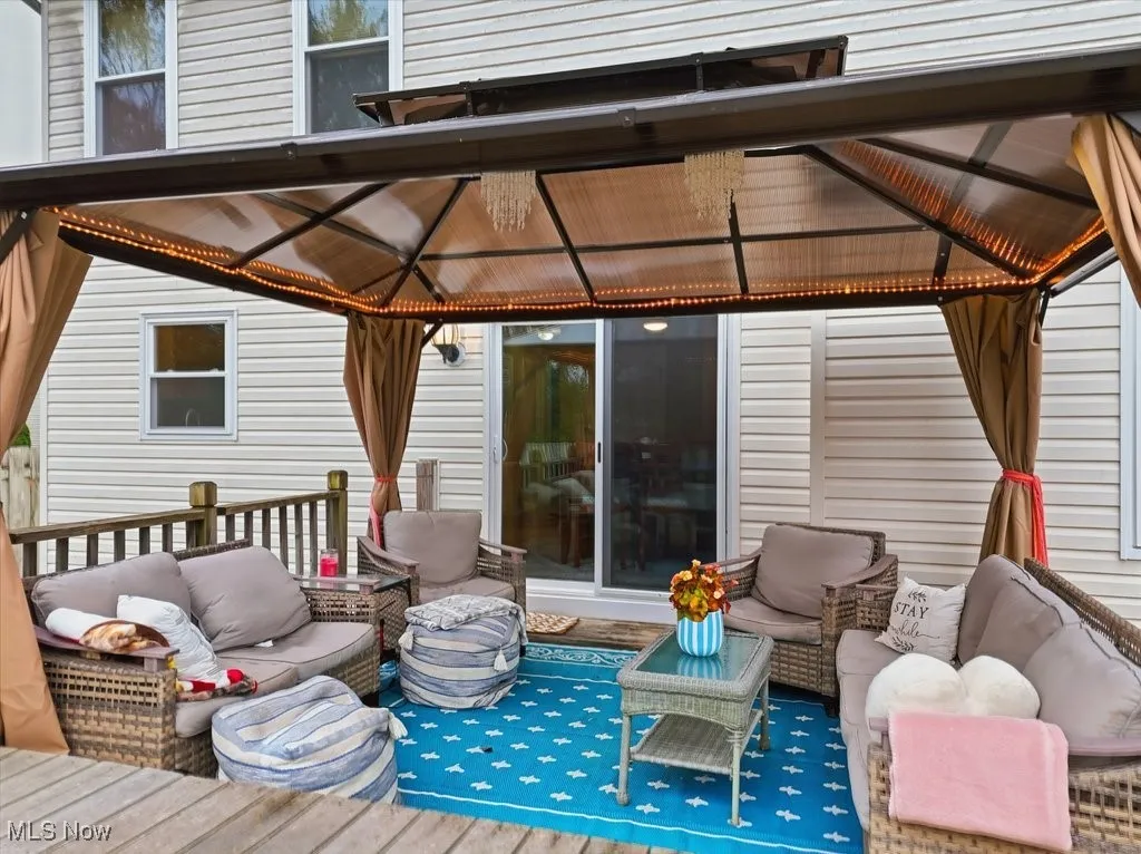 Wooden terrace featuring outdoor lounge area and a gazebo