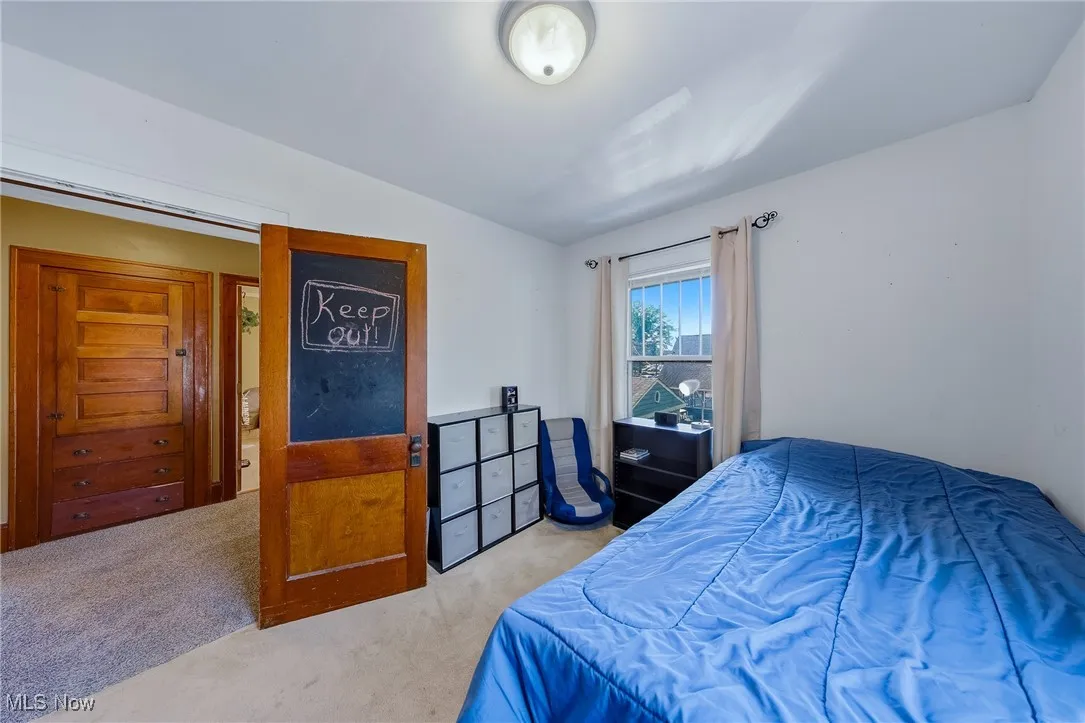Bedroom featuring carpet flooring and vaulted ceiling