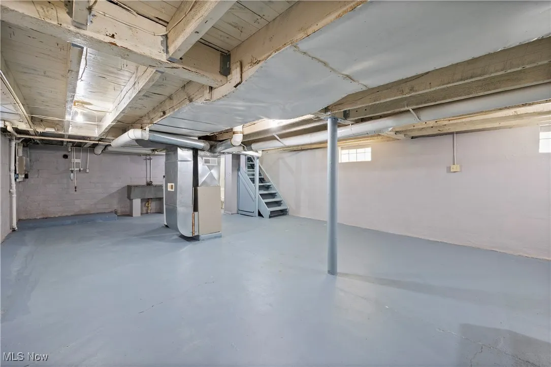 Below grade area with stairway and heating unit