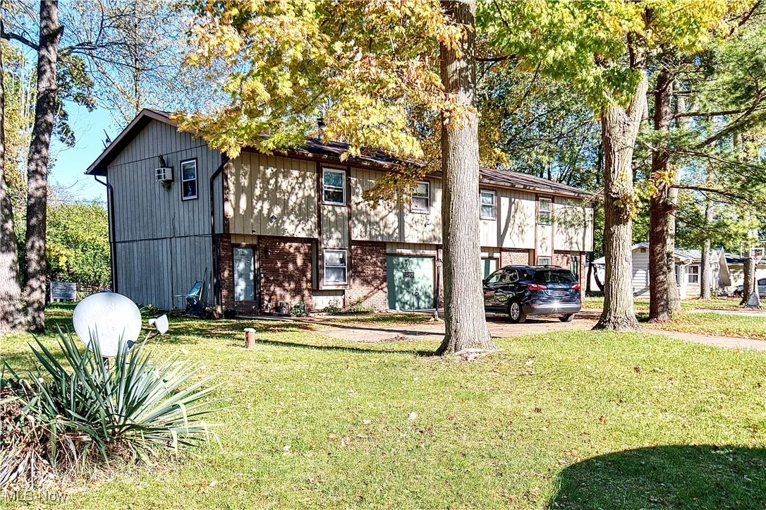 View of front of house with a front lawn and brick siding