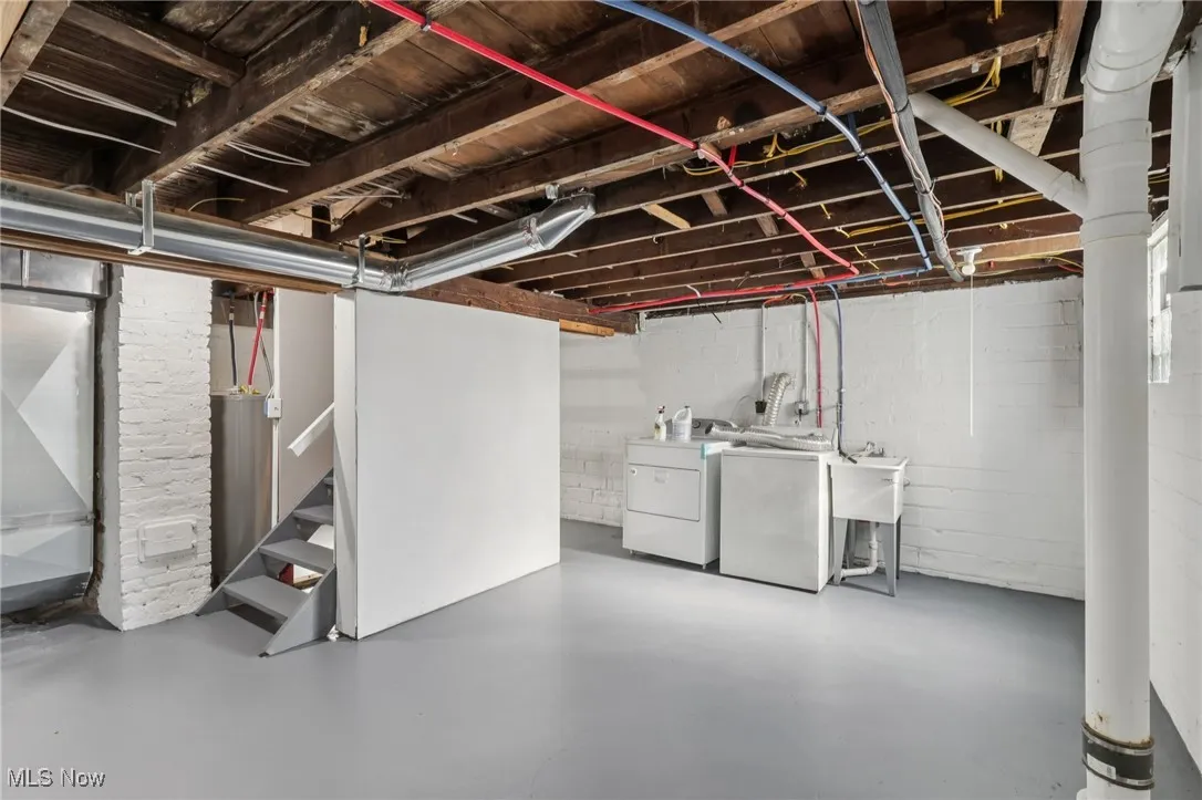 Unfinished basement with stairway and washing machine and dryer