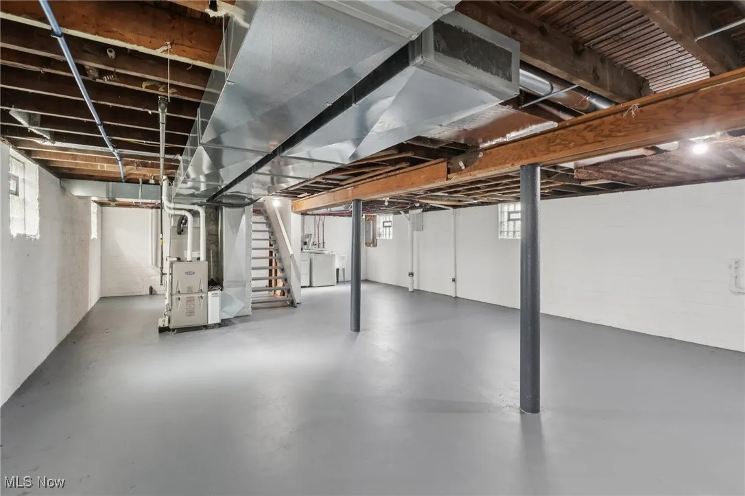 Below grade area with stairs and heating unit