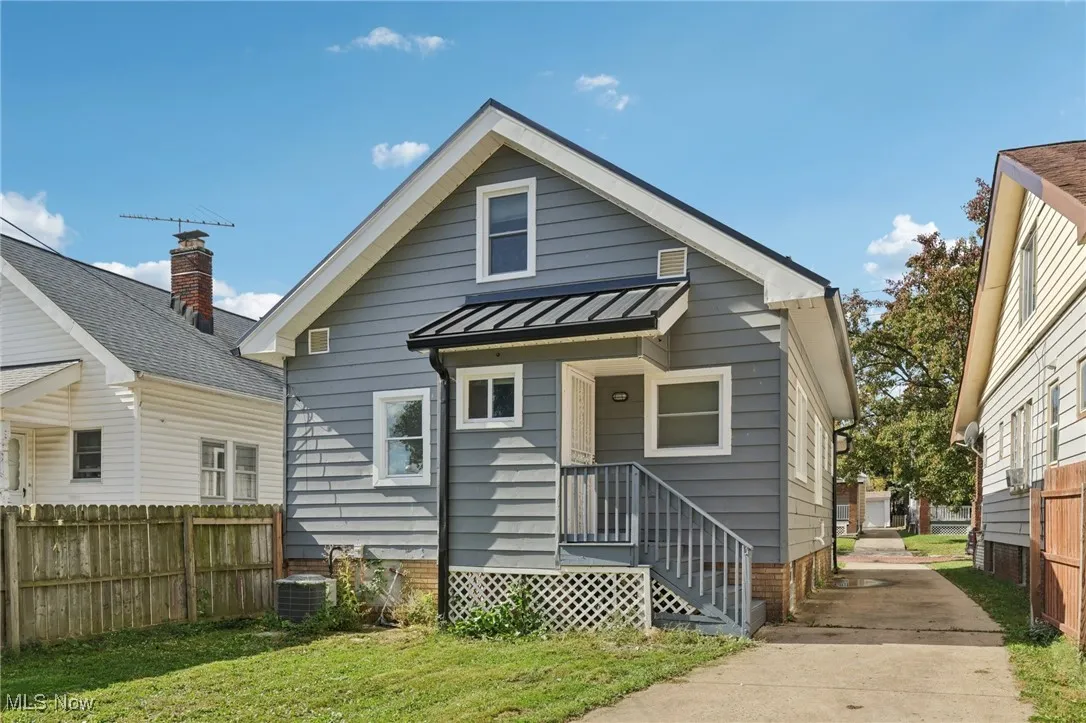 Back of house with a standing seam roof and a metal roof
