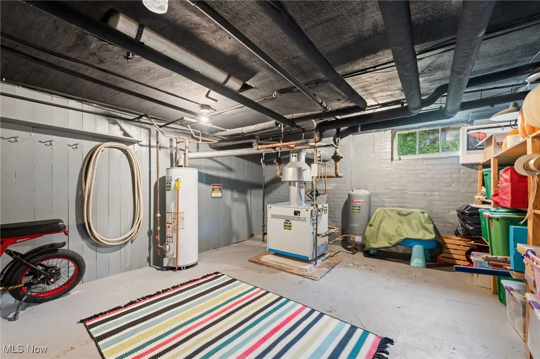 Basement with water heater and a heating unit