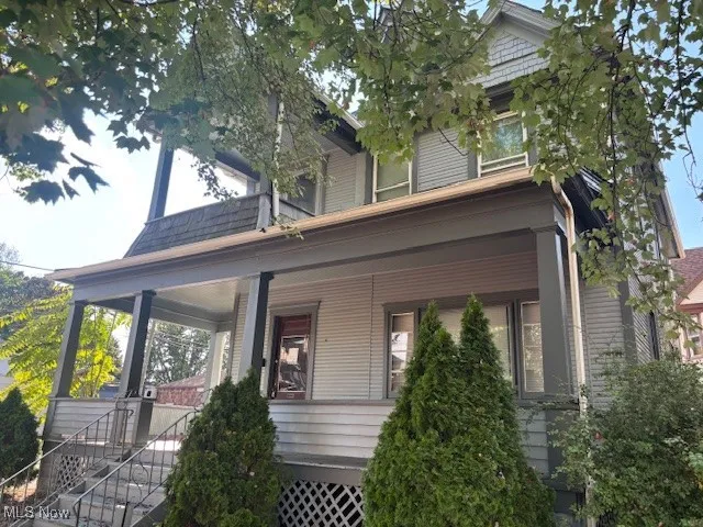 View of front facade with a porch and stairway