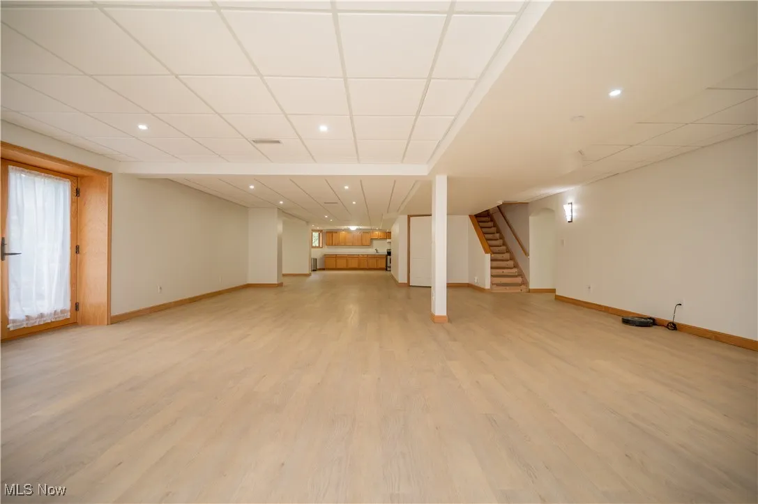 Finished living suite in the basement, family room with doors leading to a private Circular patio space.