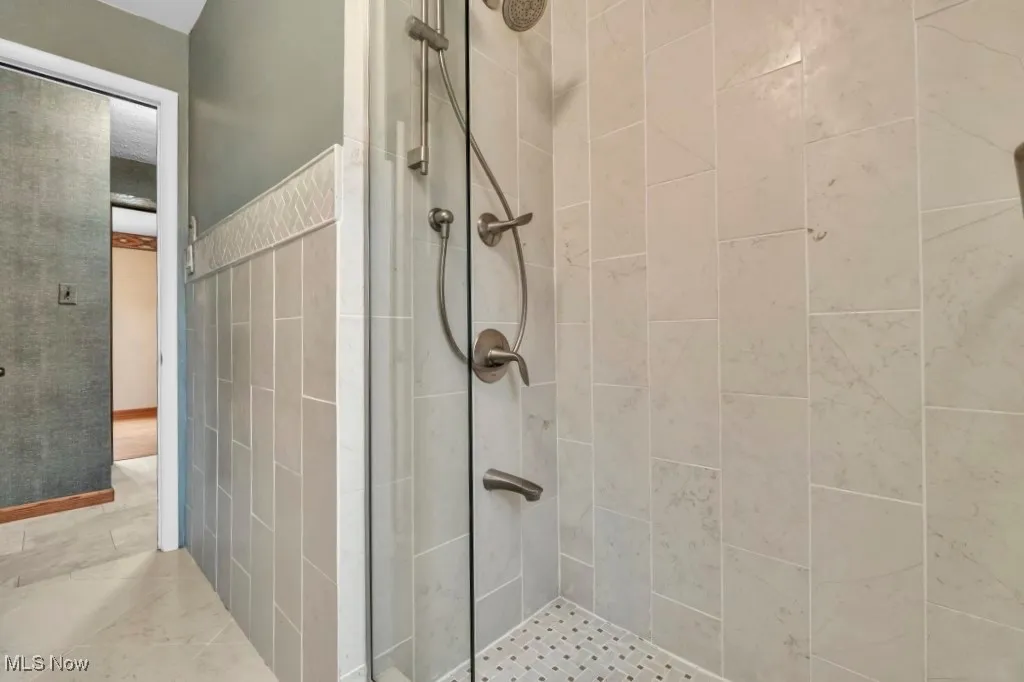 Full bathroom featuring a shower stall