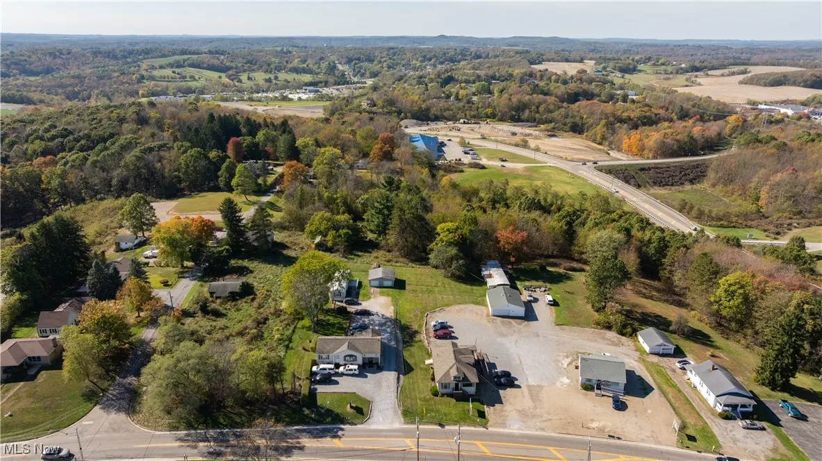 Aerial view of property and surrounding area featuring a large body of water
