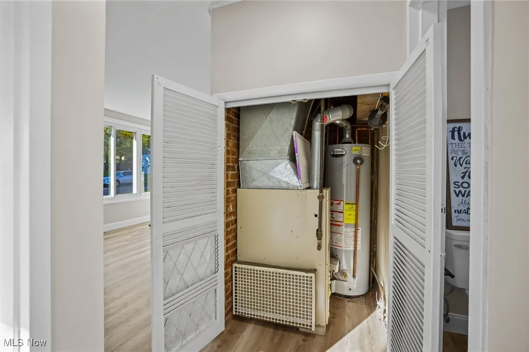 Utility room with gas water heater and heating unit
