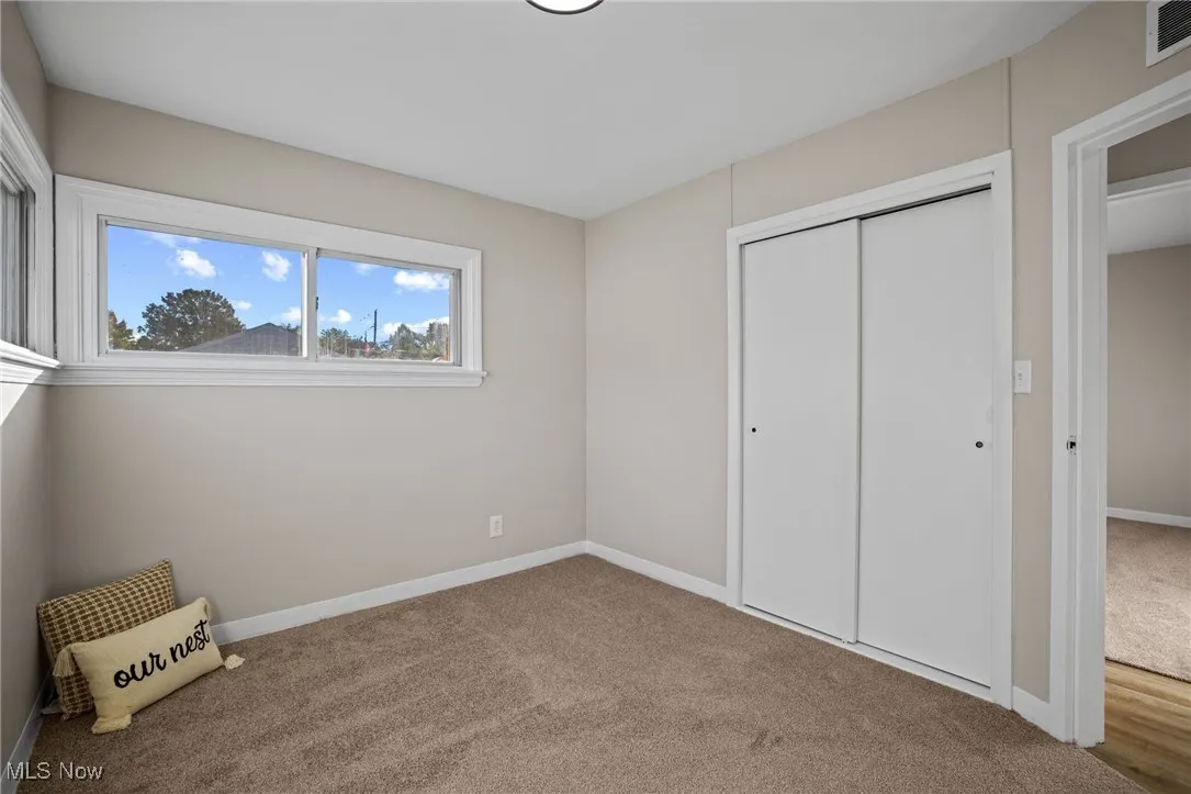 Unfurnished bedroom featuring carpet floors and a closet