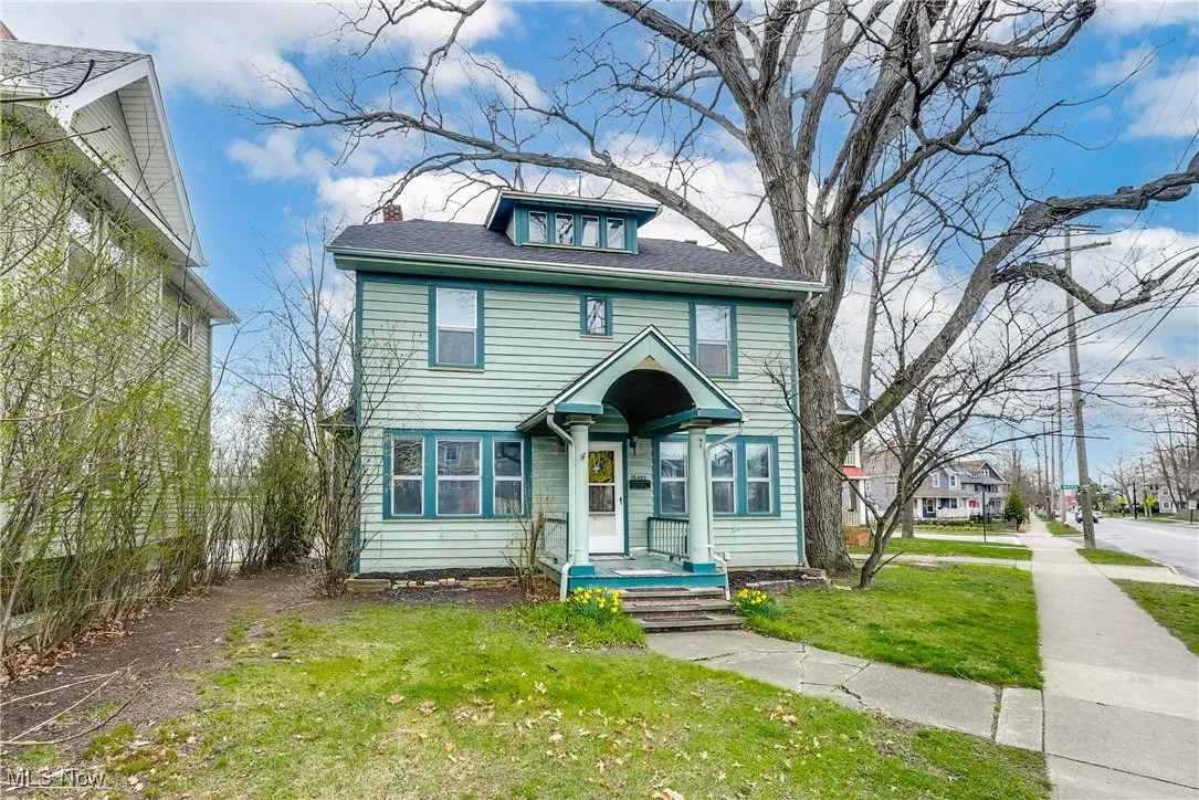 Traditional style home with a front yard, a chimney, and roof with shingles