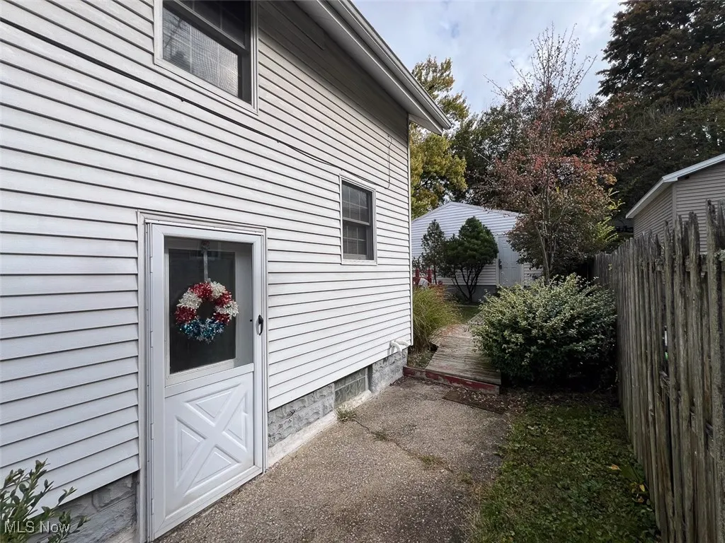 View of side of home featuring a deck